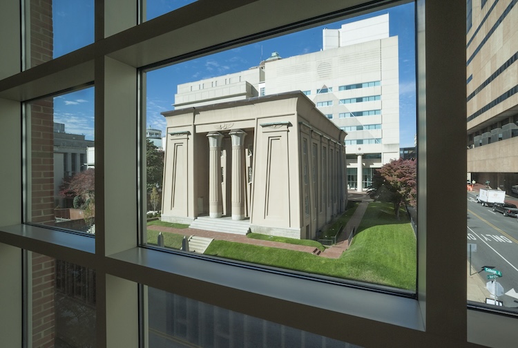 egyptian building seen through windows of another building