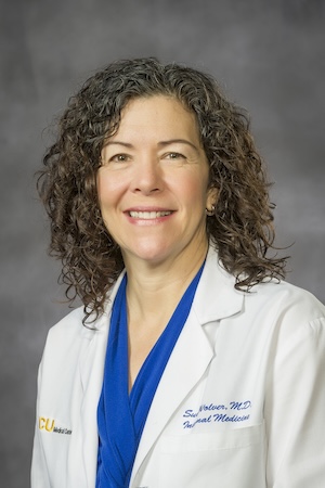 Dr. Susan Wolver wears a medical white coat