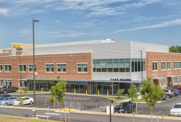 Exterior of C.A.R.E. Building’s entrance and parking area