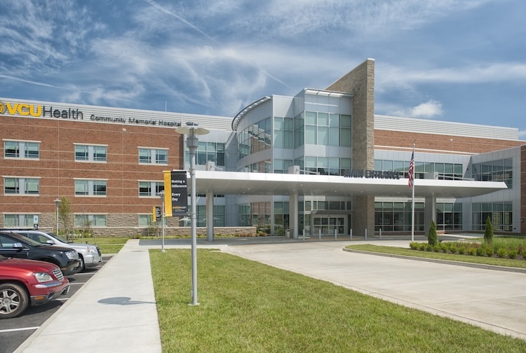 Exterior of Community Memorial Hospital’s entrance and parking lot