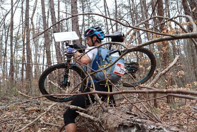 Man walking with bike in the woods