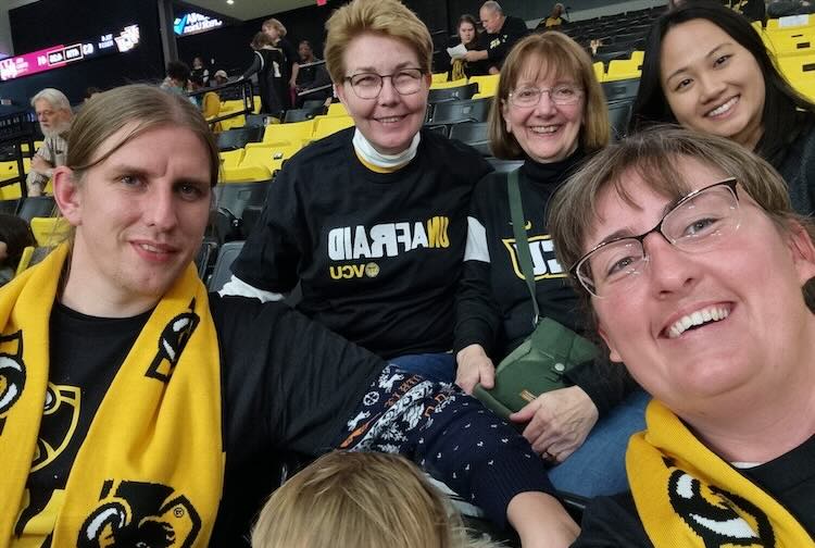 Group of individuals sitting in the bleachers at VCU Basketball game