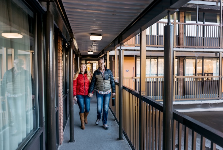 two people walking on a hotel balcony 