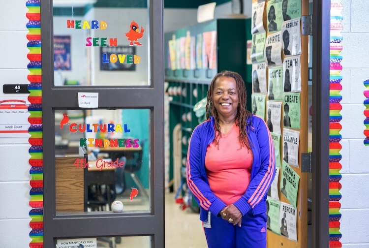 Phyllis Byrd stands in the doorway of her classroom.