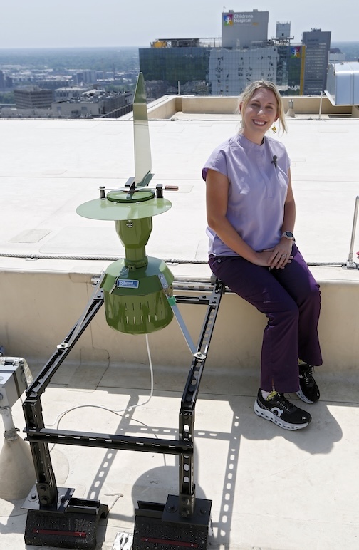 Jessica Hess, CPNP, next to the air sampler
