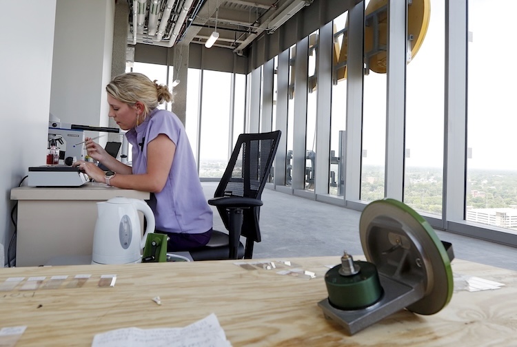 Woman sitting at a desk in an office in a tall building