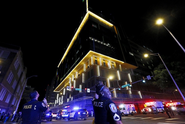 Nighttime around the Children's Tower with police officers smiling and shining lights