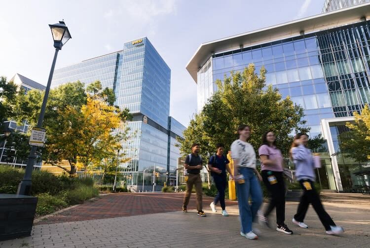 Students walking near VCU and VCU Health buildings in a city