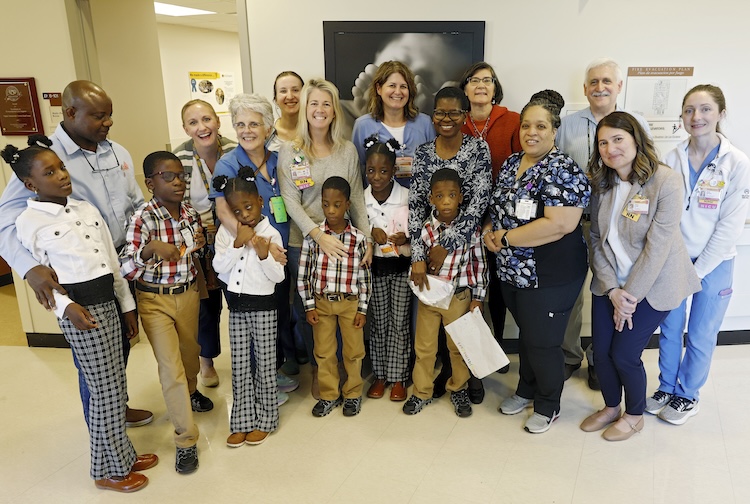 The Taiwo family surrounded by their old care team at CHoR