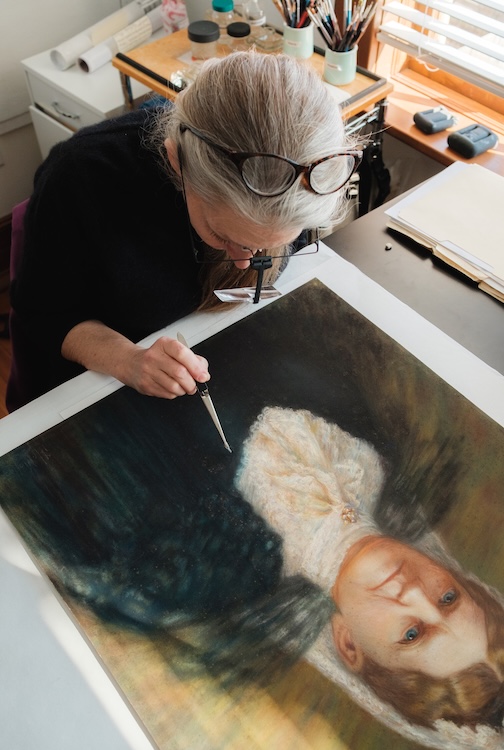 Wendy restoring on a painting