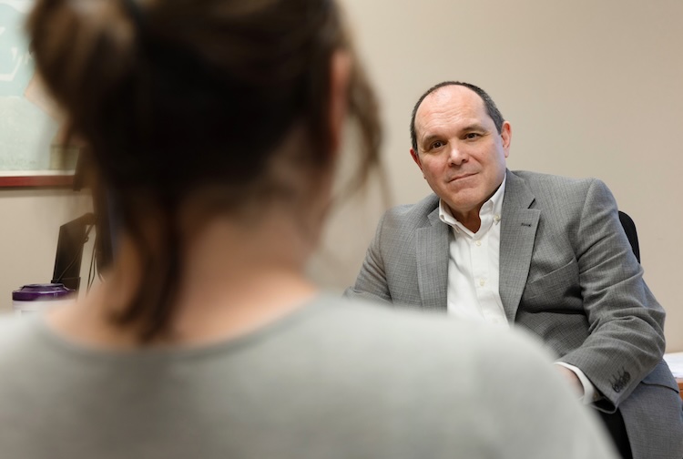 Beyers talking with an individual
