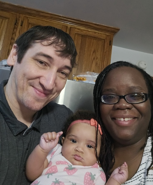 Family photo with baby who was born after their parents wedding at VCU Medical Center
