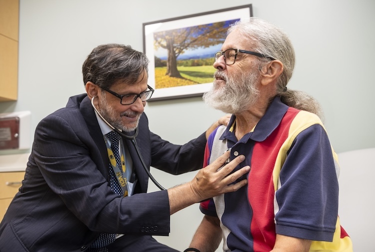 Dr. Sanyal listens to a patient’s heart during a check-up