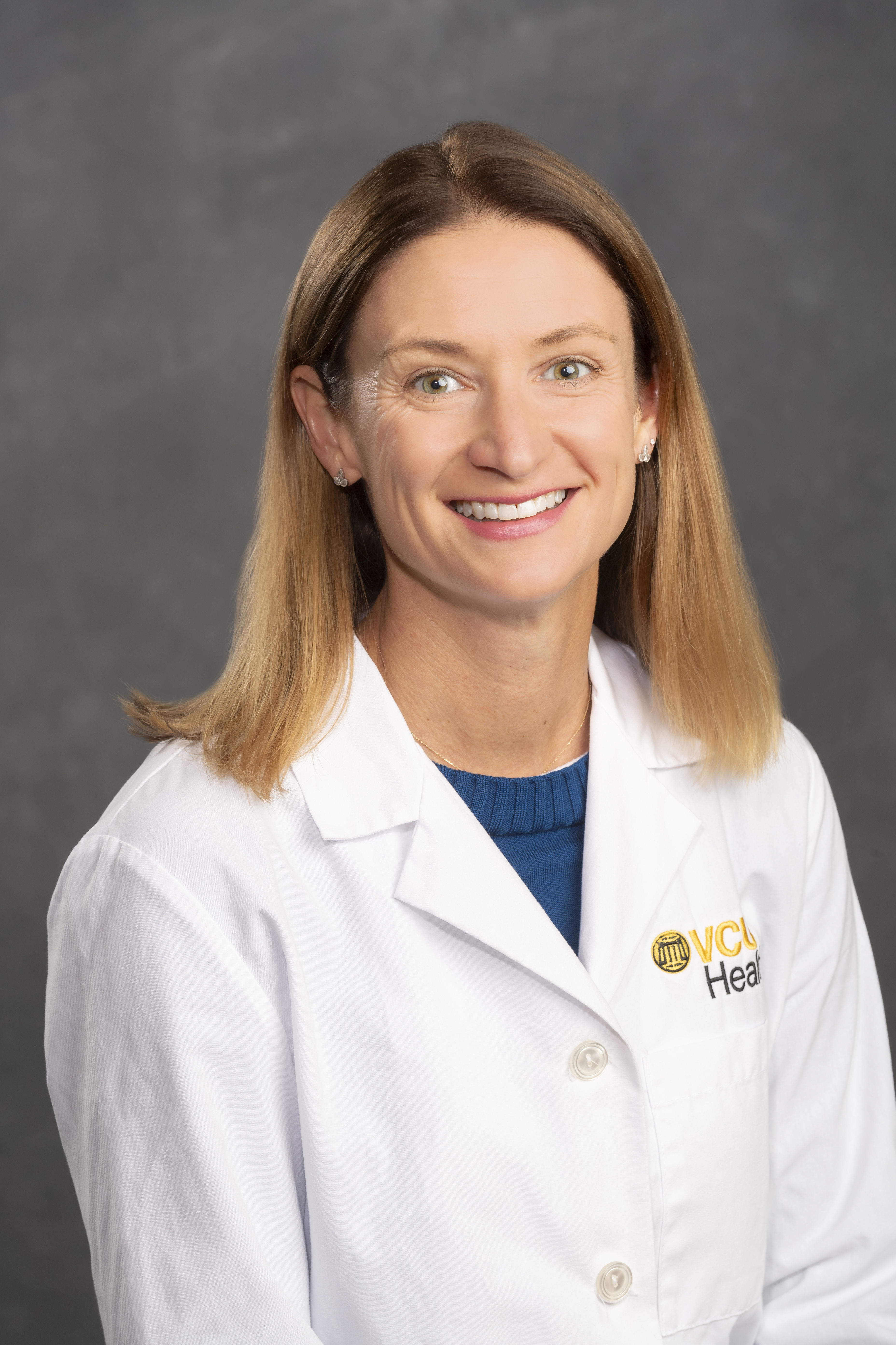 Dr. Limmer sits in her medical white coat