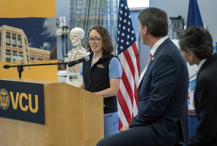 Megan Huntley stands at a podium