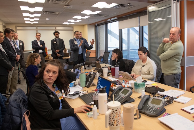 Busy room with a lot of people talking and on phones