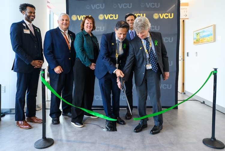 VCU Health and VCU leaders cut a green ribbon to mark the opening of the new unit.