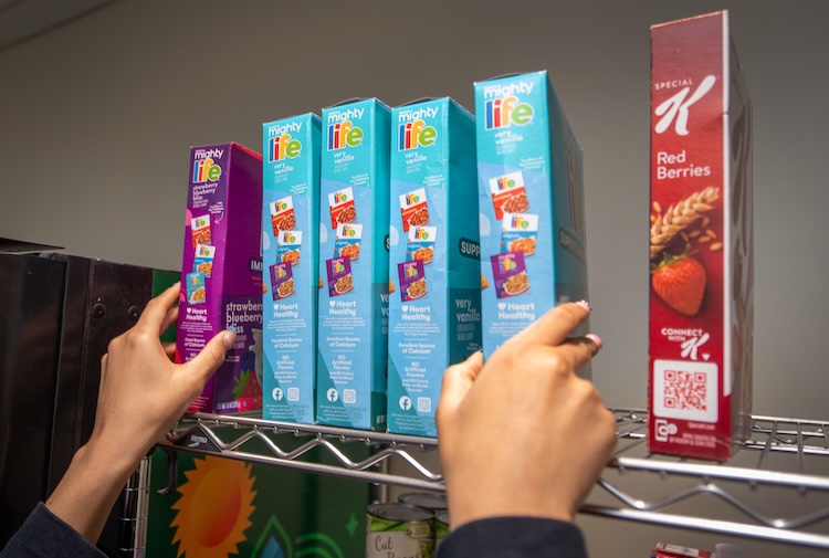 Student puts cereal on a shelf