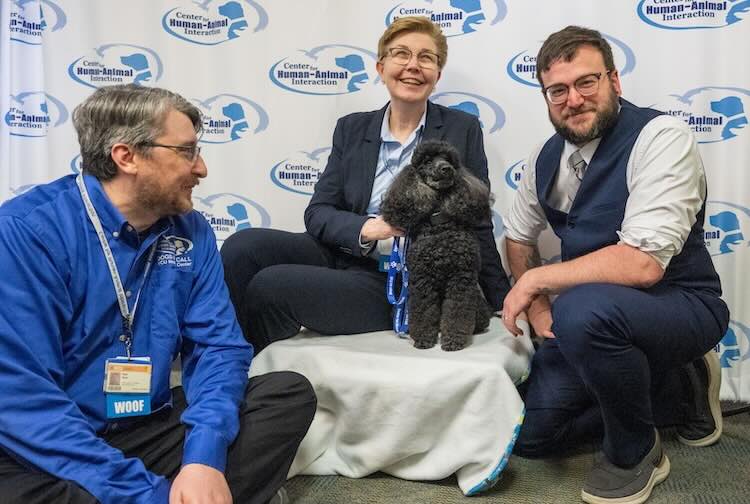 Picture of Dr. Gee and CHAI Staff with Allie the black poodle