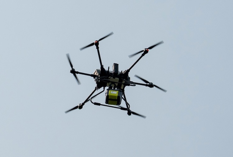 Drone flying in the sky with the AED.