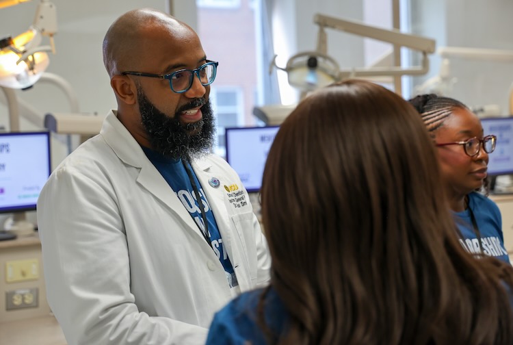 Dr. Carlos Smith talking to students
