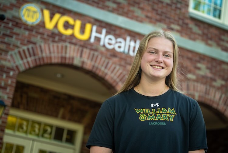 ACL tear patient Taylor stands outside the VCU Health William & Mary clinic in Williamsburg, Virginia.
