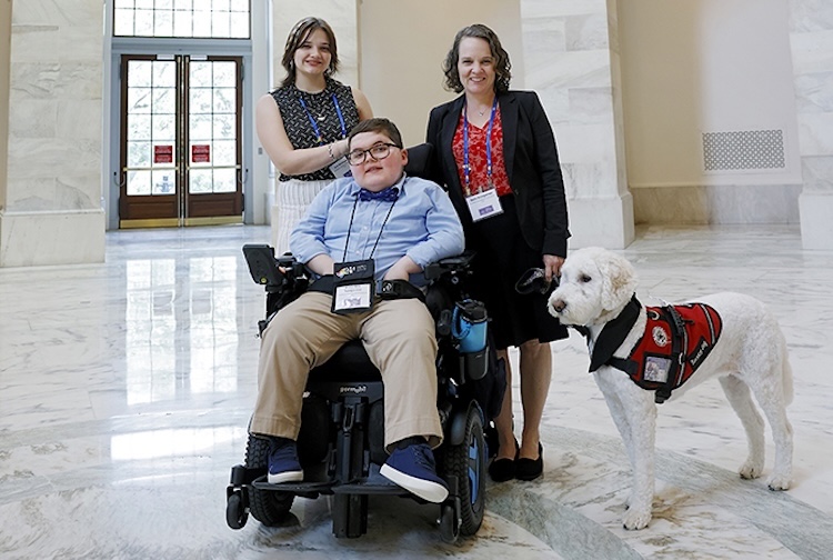 Ben, his mom Beth, sister Ace and service dog Divina at the Capitol during Family Advocacy Day.