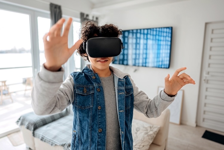 Boy playing with a virtual reality headset in his room.