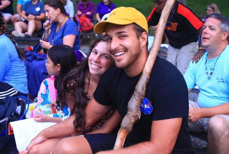 The Monks smile while sitting at an event at camp