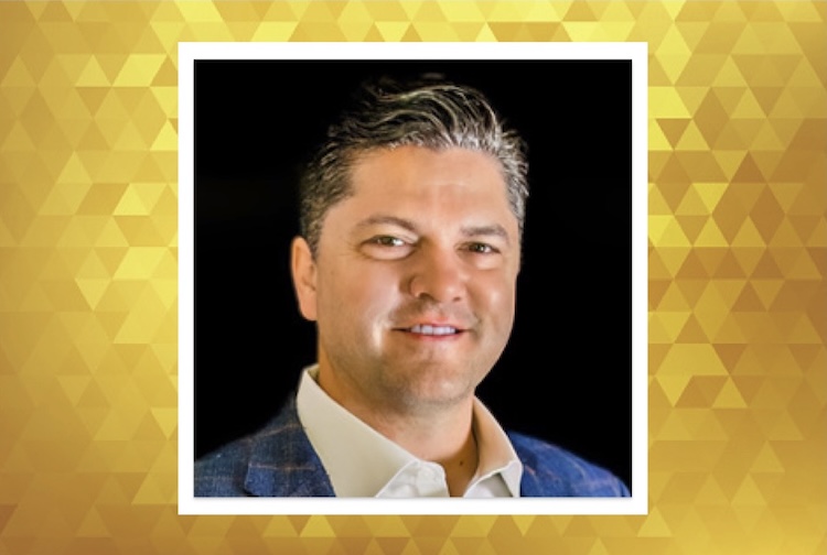 Burkett is wearing a blue suit and white shirt