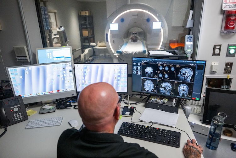 man looking a scans of the brain on a computer from MRI