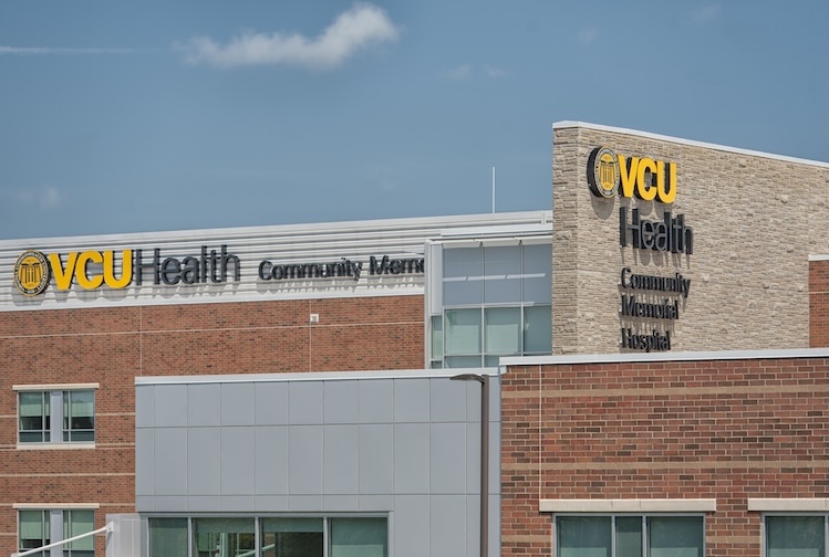 Exterior of the hospital with a close-up on signs that say VCU Health Community Memorial Hospital