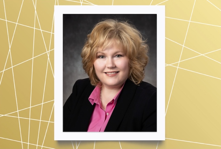 Woman in pink shirt and black suit jacket