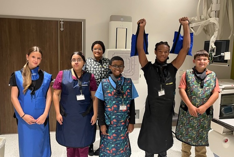 Campers wear protective vests as they learn about x-rays
