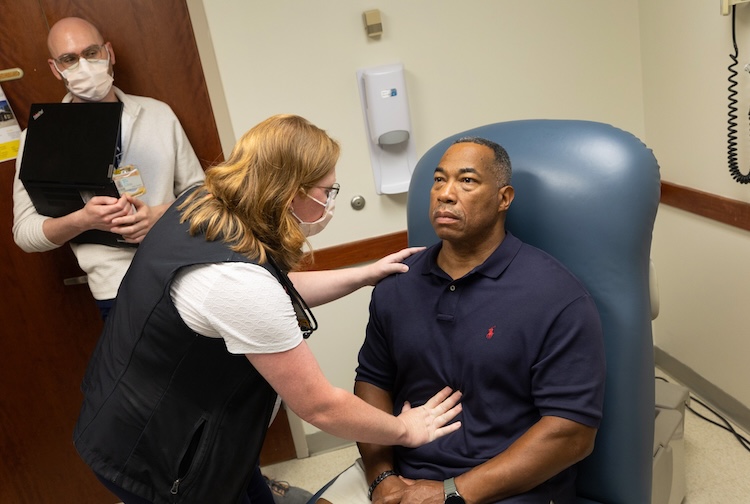 A VCU Health team member examines amyloidosis patient Johnny Boatman.