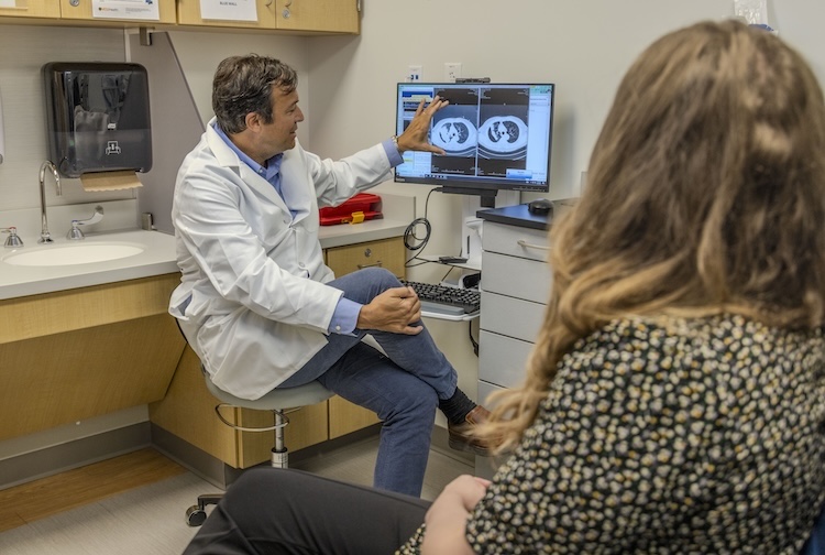 man speaking woman in a patient room