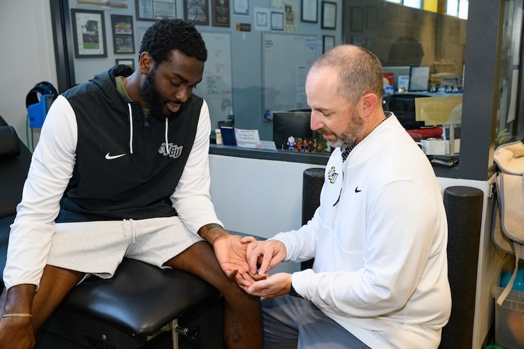 Cheatham examines Joe’s finger in the clinic
