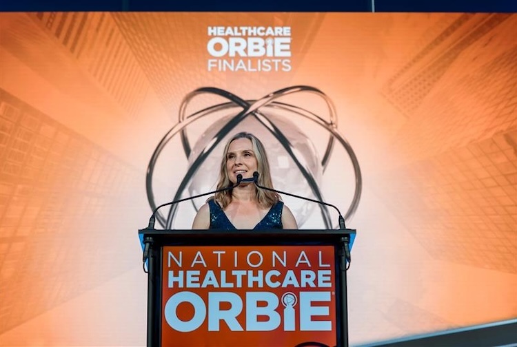 Wiegand accepts her award on a stage during a ceremony