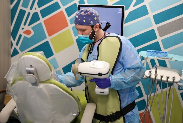 Dr. Bloom examines a child’s teeth