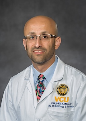 Dr. Main wears his medical white coat and has a colorful tie