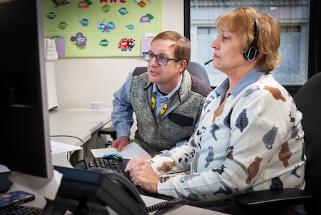 Dr. Downs and a nurse looking at computer monitor screen.