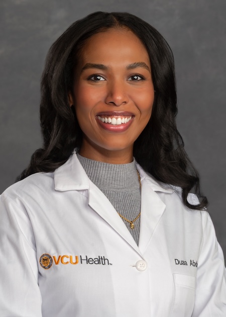 Dr. Hameid wearing a grey blouse and wearing VCU Health white coat.
