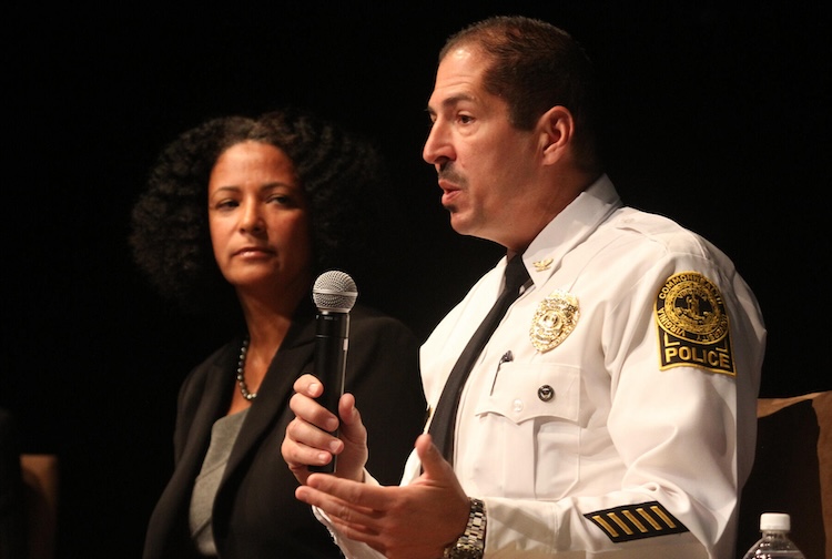Man holding mic speaking to crowd