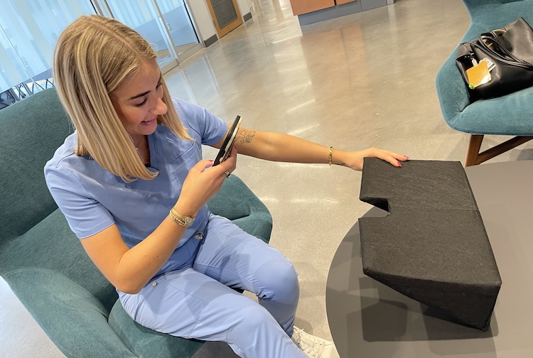 Emma is very happy to see the first prototype of the device she designed with Casey.