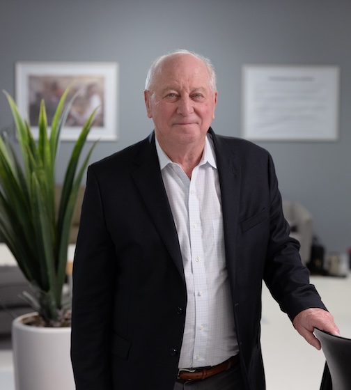 man wearing a suit stands in an office