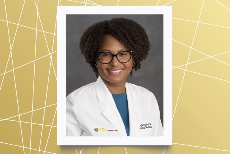 Dr. McInTosh is wearing a white medical coat and glasses