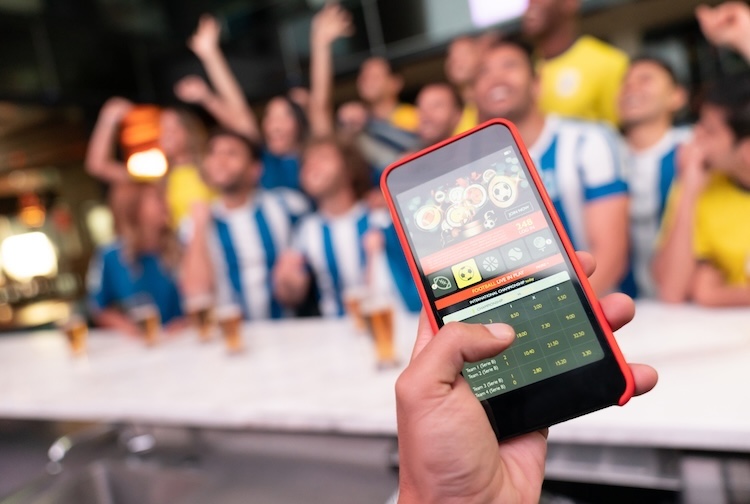 Person wins an online bet on their phone during a soccer game