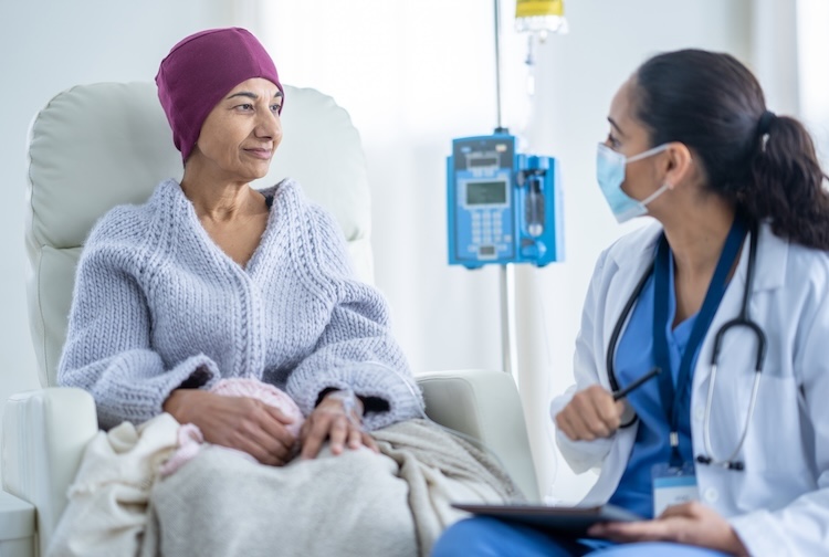 cancer patient speaking with oncologist during a chemotherapy treatment.