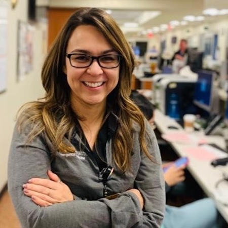 Dr. Hickam, wearing a grey long sleeve shirt.
