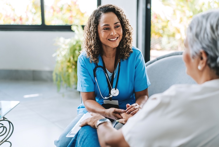 Nurse visits with patient in their home